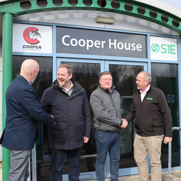 men shaking hands outside Cooper House