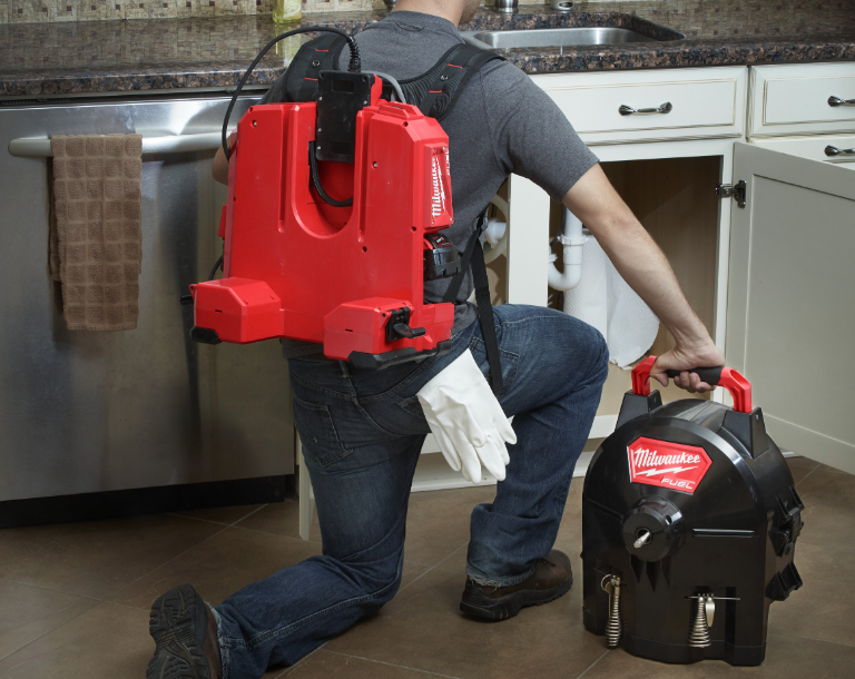 man using Milwaukee equipment in a domestic kitchen